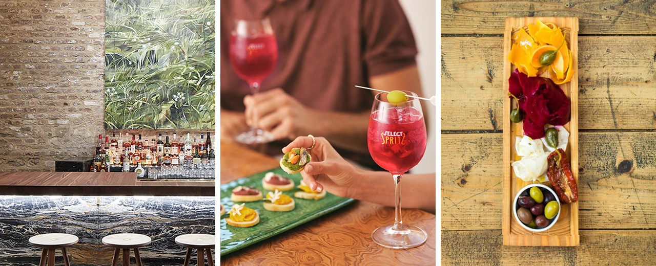 Bild einer Bar mit tropischem Dekor, einem Glas Select Spritz und einer Antipasti-Platte. Perfekt für Aperitif und gemütliche Abende.