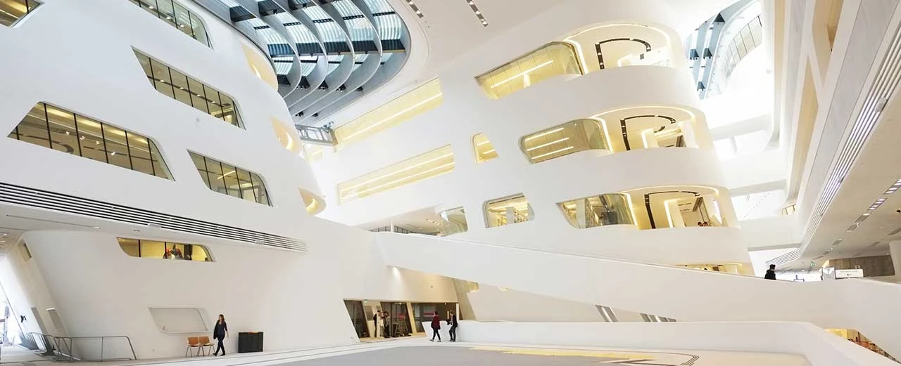 © Miriam Kummer Moderne Architektur der Zentralbibliothek Wien: Weiße, fließende Linien & Glasflächen.