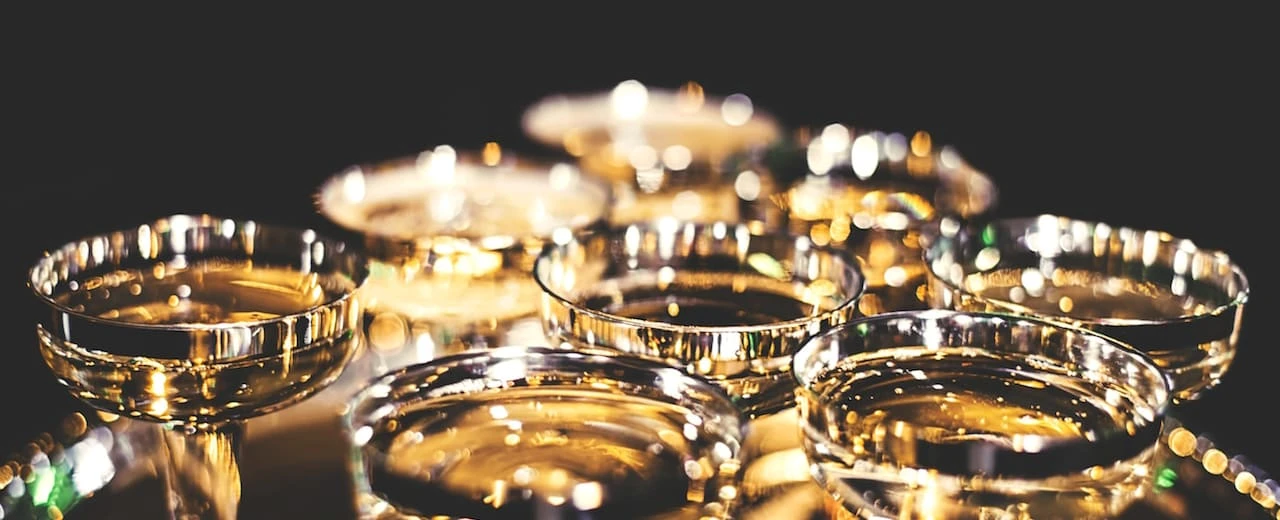 Nahaufnahme mehrerer gefüllter Champagnergläser auf dunklem Hintergrund. Festliches Bild.