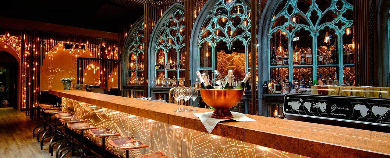 Luxuriöse Bar mit gotischem Design, Kupfer- und Türkis-Akzenten, Champagnerkühler und edlen Gläsern. Foto von Benedikt Steinle, kitchenkonsulting.at