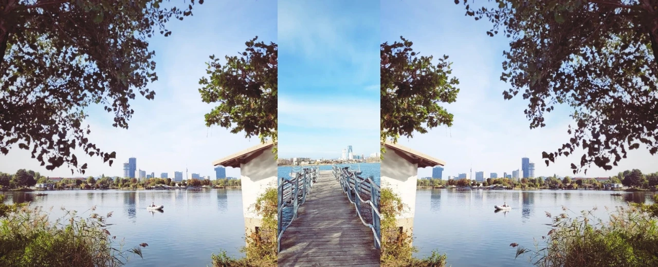 Idyllischer See in Wien mit Steg und Stadtkulisse. Natur und Stadt in harmonischem Zusammenspiel.