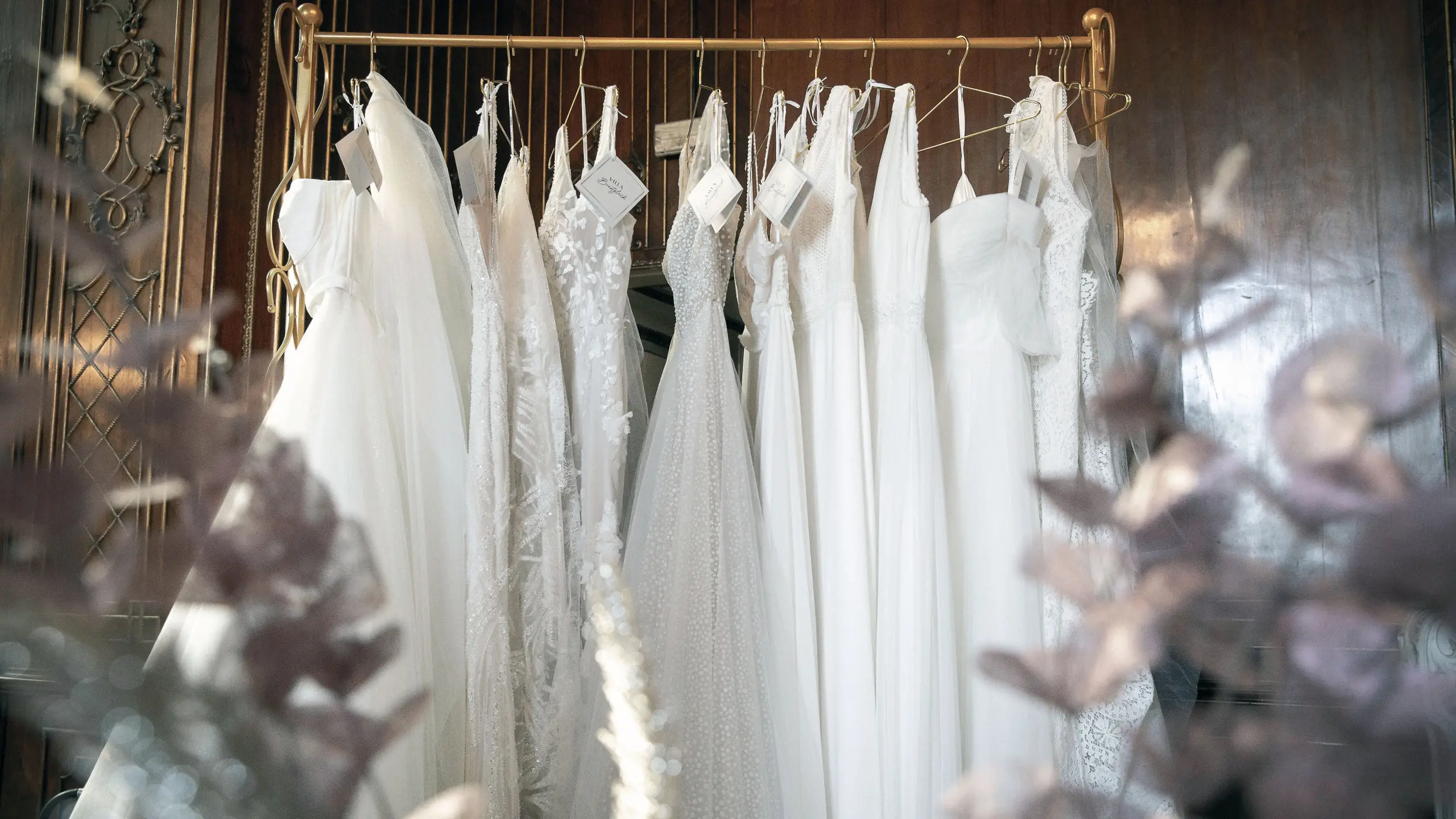 Brautkleider, die auf einer Kleiderstange hängen