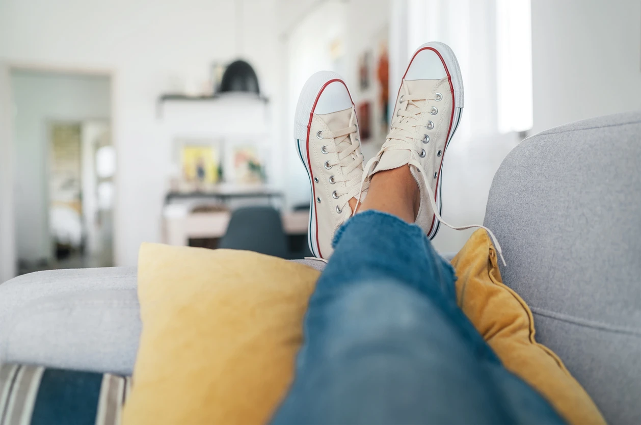 Eine Person liegt auf einer Couch.