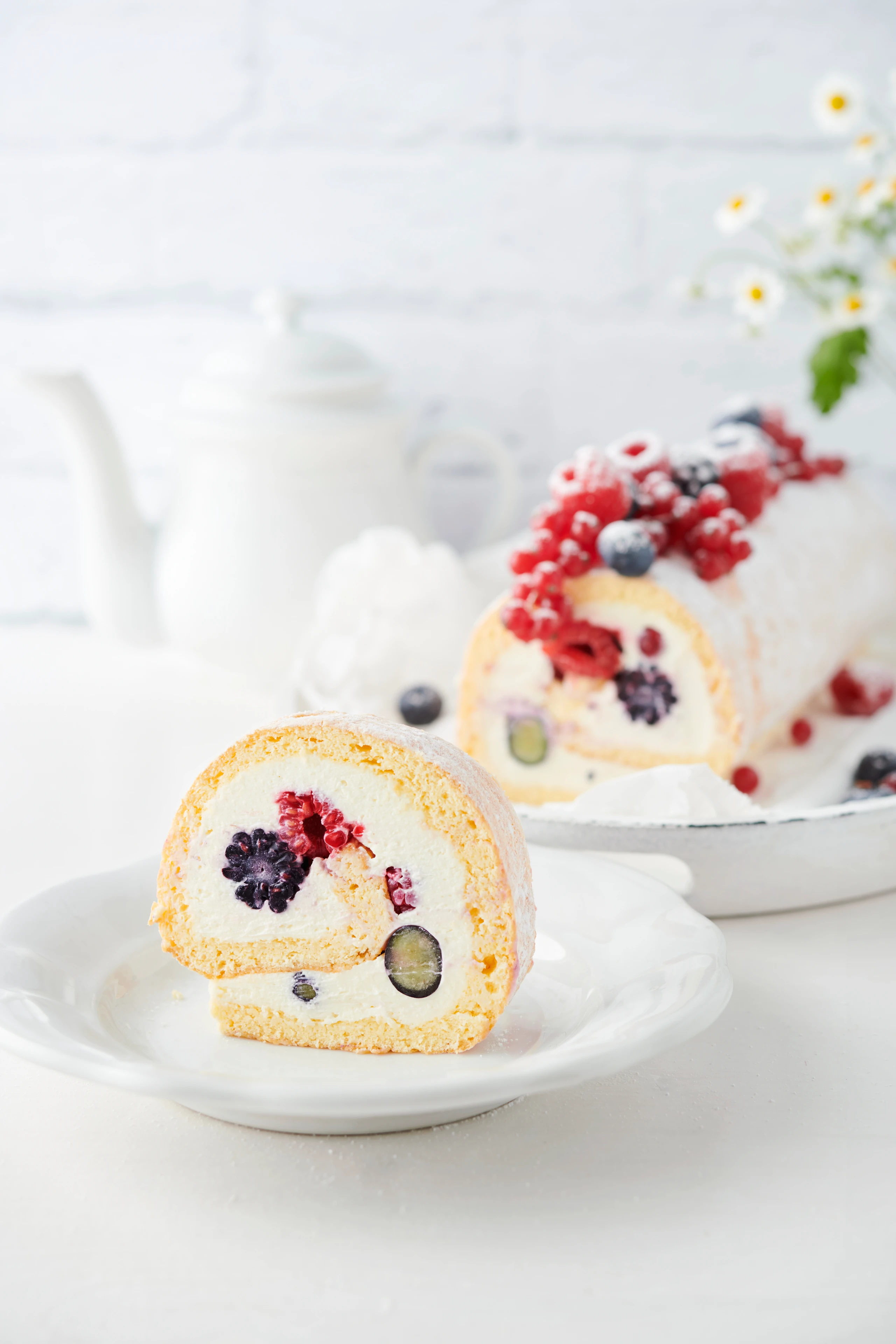 Biskuitroulade mit bunten Beeren