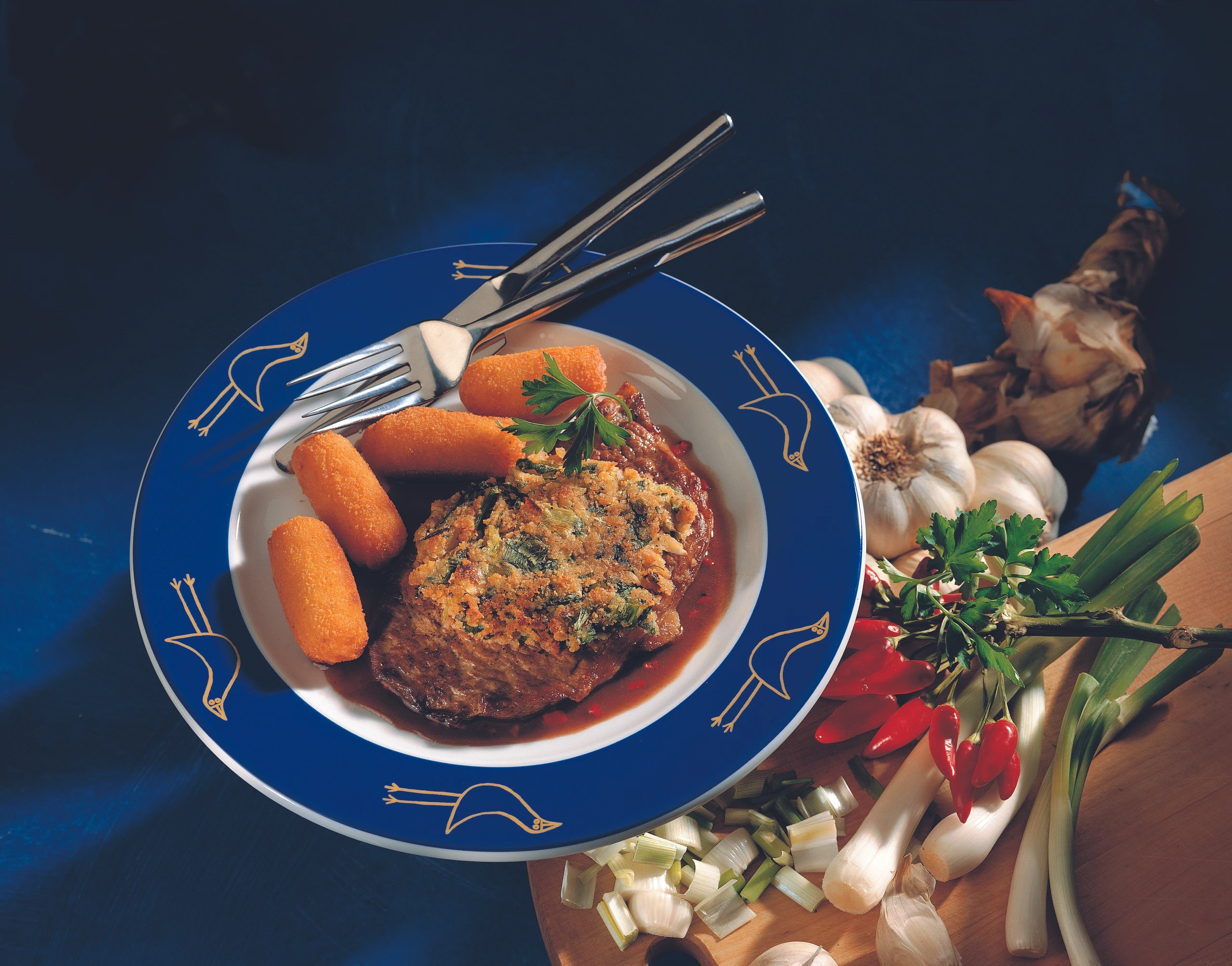 Rindsschnitzel mit Zwiebel-Kräuterkruste und Erdäpfelkroketten