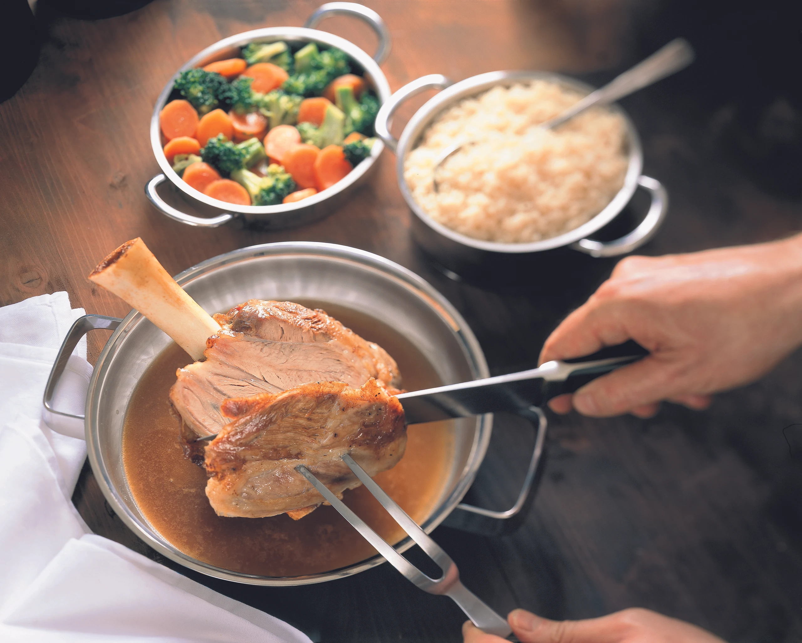 Gebratene Kalbsstelze mit gedünstetem Reis und Brokkoli-Karottengemüse