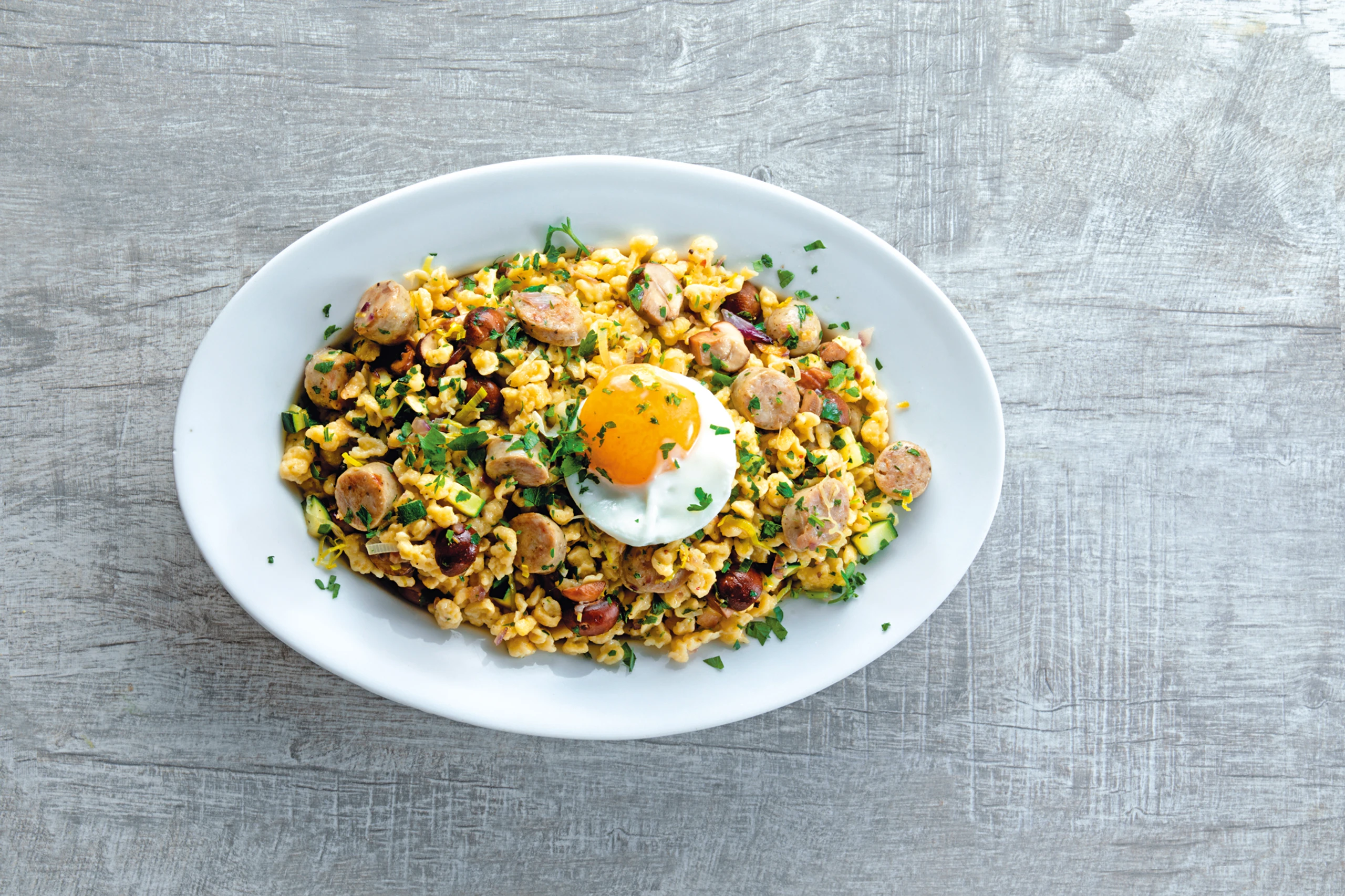 Nockerlpfanne mit Würstel und Champignons