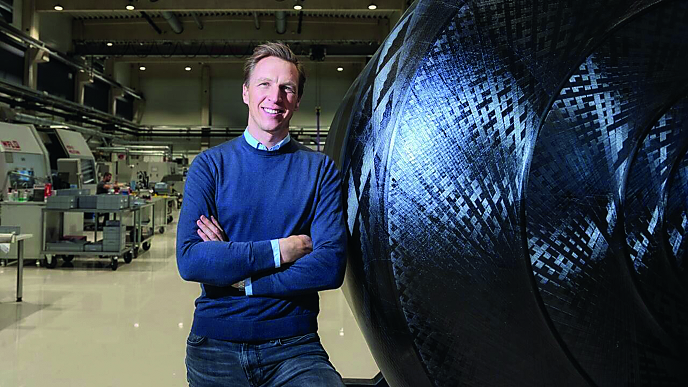 Dieter Grebner von Austrspace steht mit verschränkten Armen in einer Forschungseinrichtung.