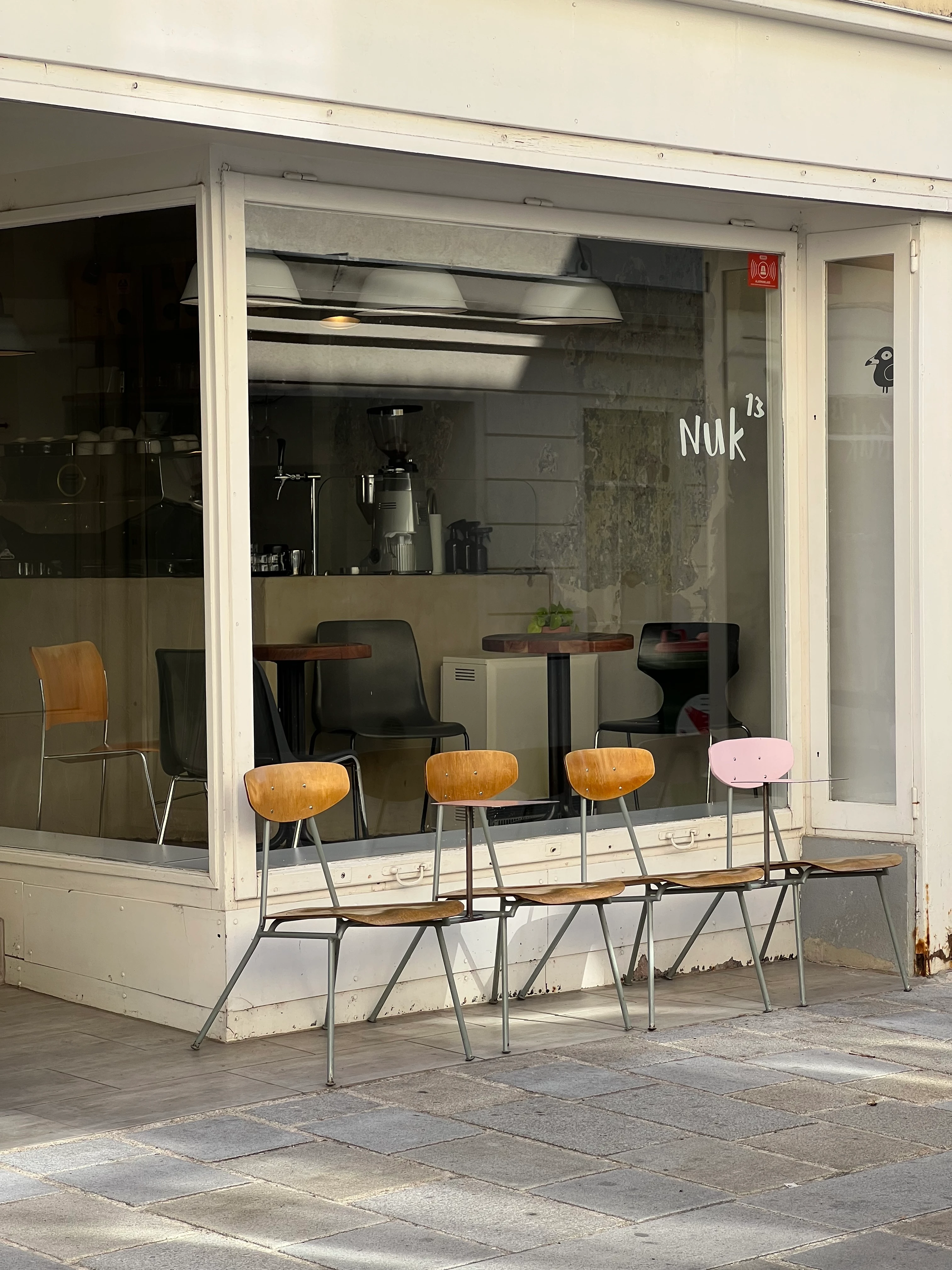 Aussenansicht von Nuk 13, einem Café mit Stühlen davor.