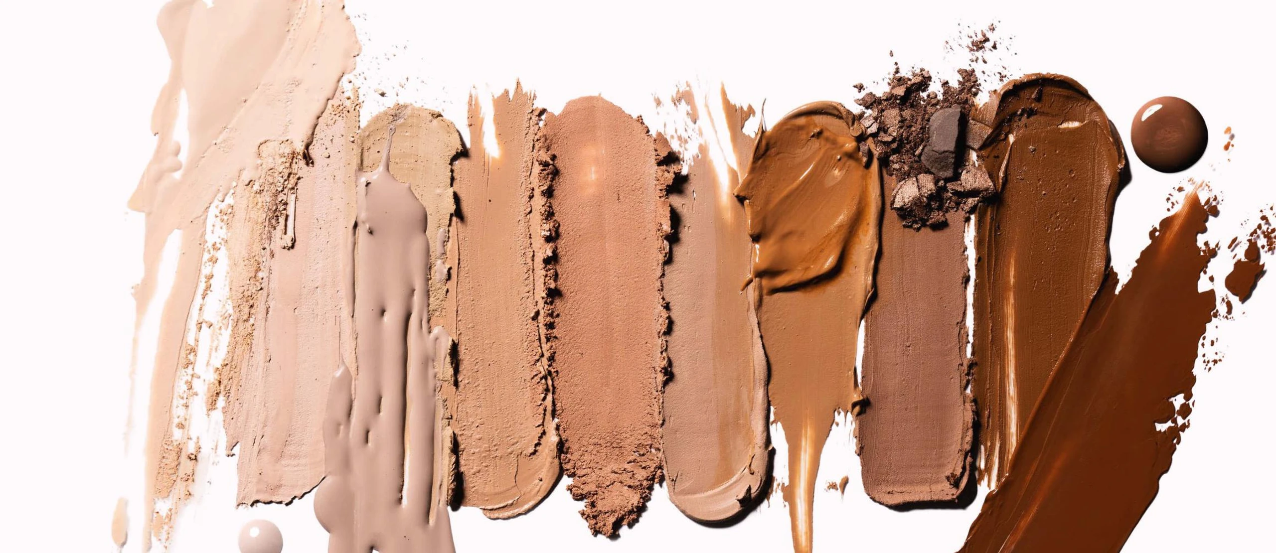 Swatches von verschieden farbigen Foundations in einer Reihe