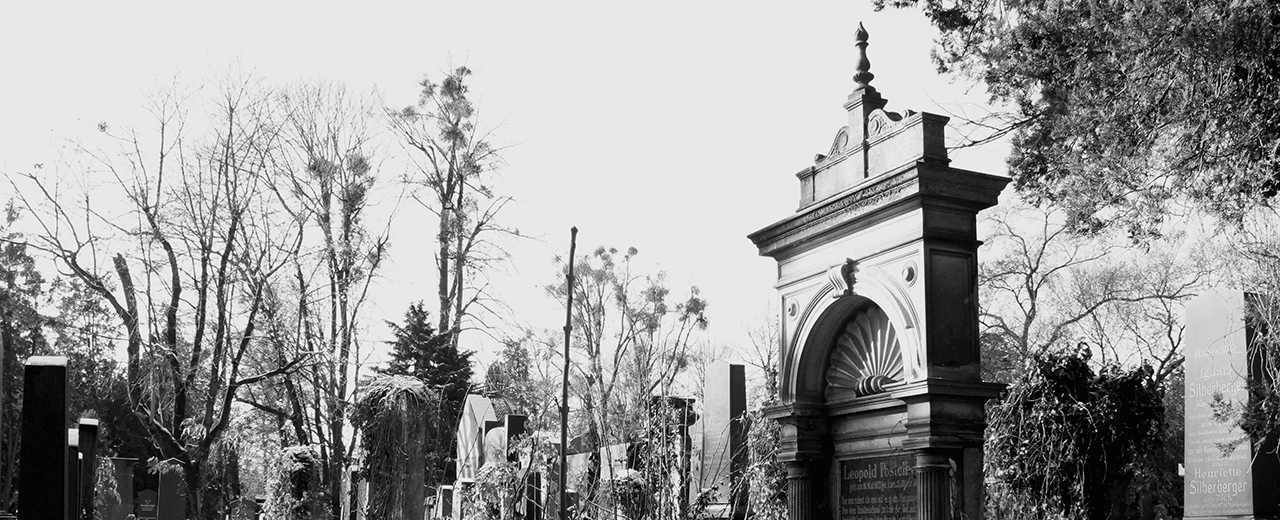 Schwarz-weiß Foto eines winterlichen Friedhofs mit aufwändigem Grabstein. Adobe Photoshop CS2 Macintosh.